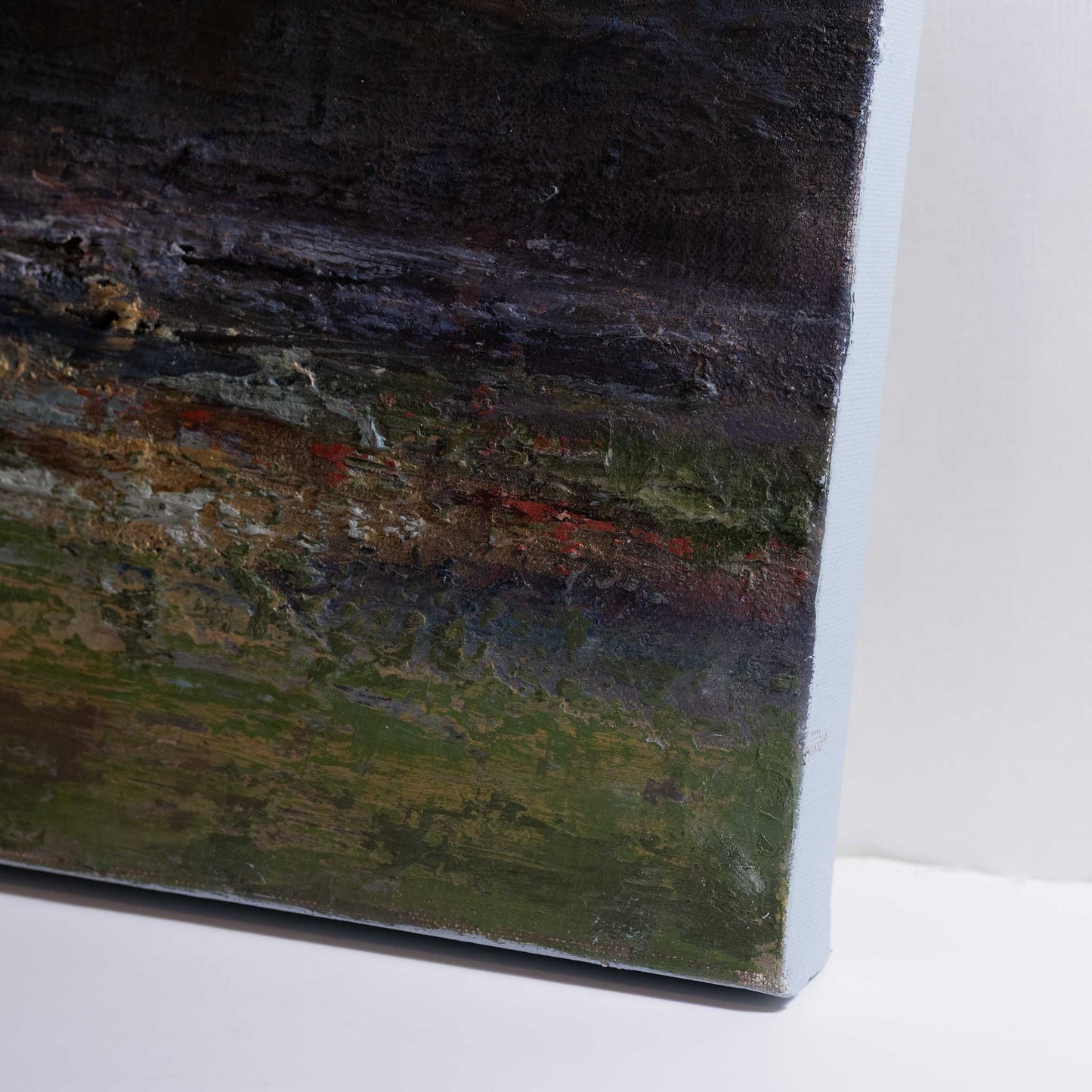 close up of right hand corner showing deep rich colours and texture