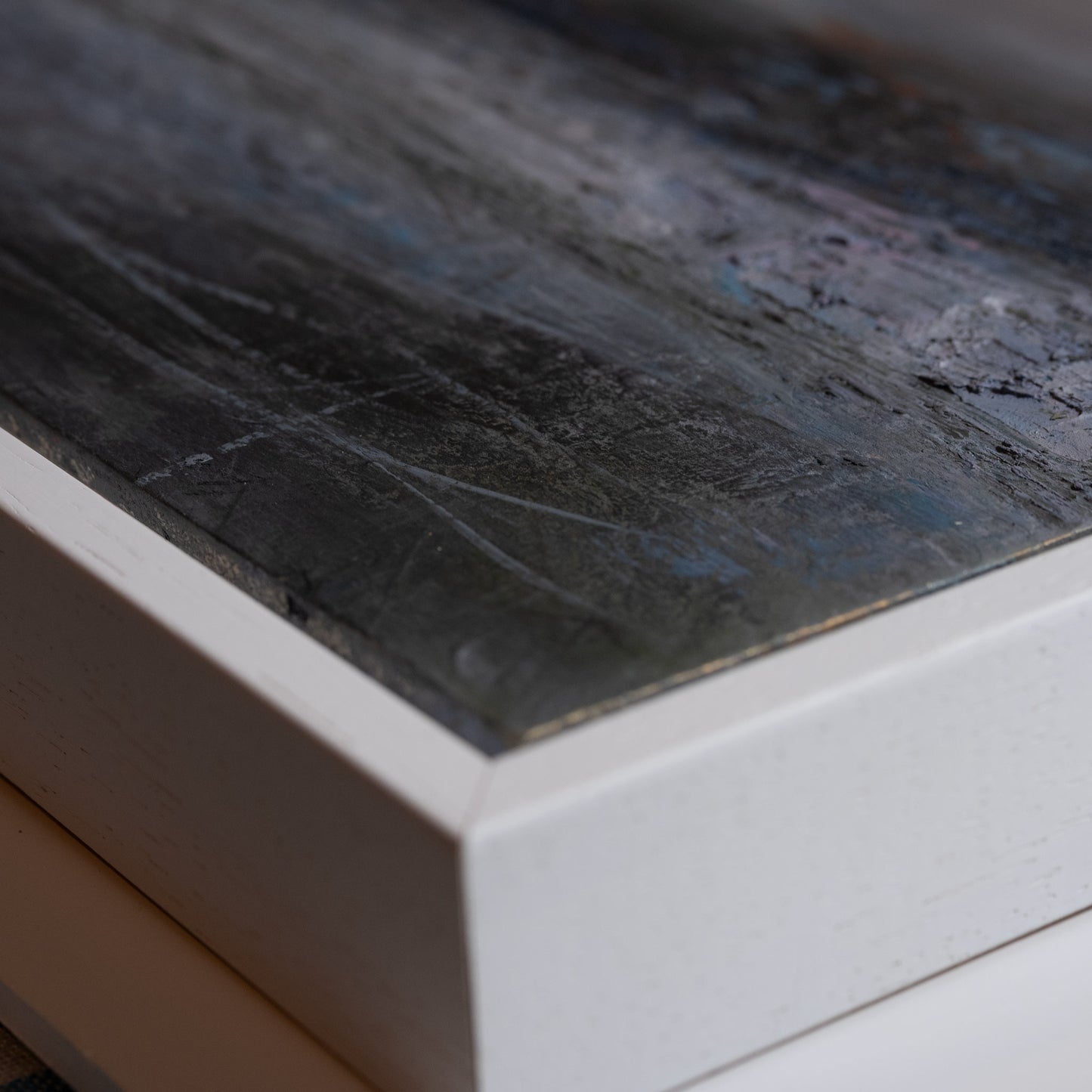 Close-up of a dark gray concrete surface with a white base