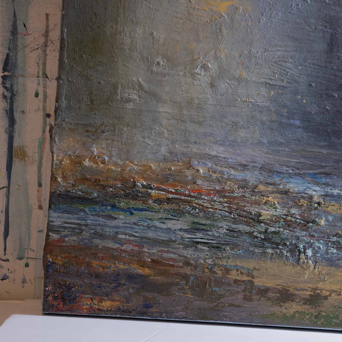 CLOSE UP OF LEFT HAND CORNER SHOWING LAYERED TEXTURE IN RICH COLOURS