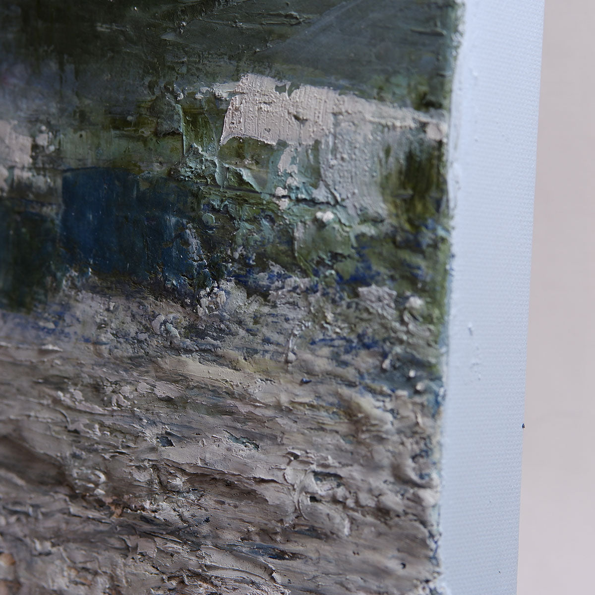 Close-up of a textured surface with edge of painting on right hand corner